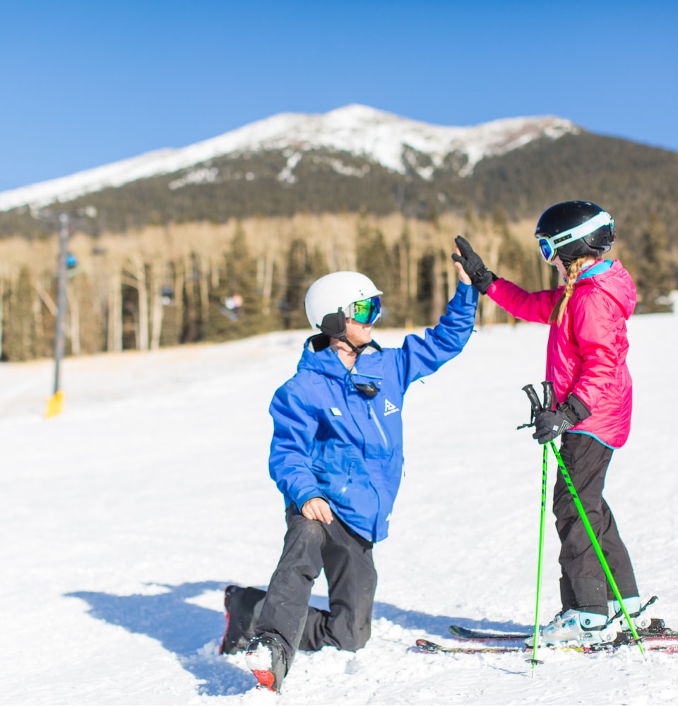 ski instructor high fives student