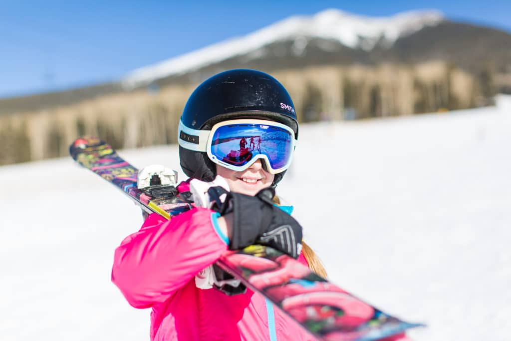 Child holding skis at Arizona Snowbowl.