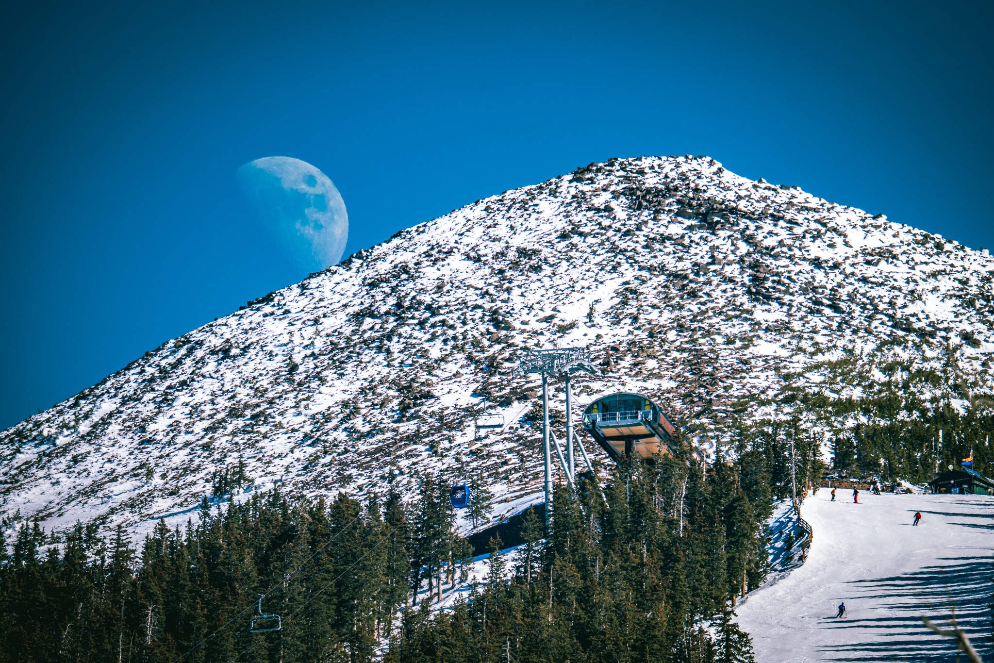 Drone shot of moon above Agassiz Peak and Arizona Gondola.