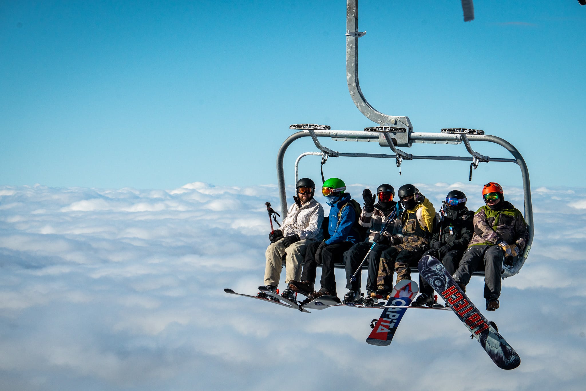 Riders on chairlift above clouds at Arizona Snowbowl.