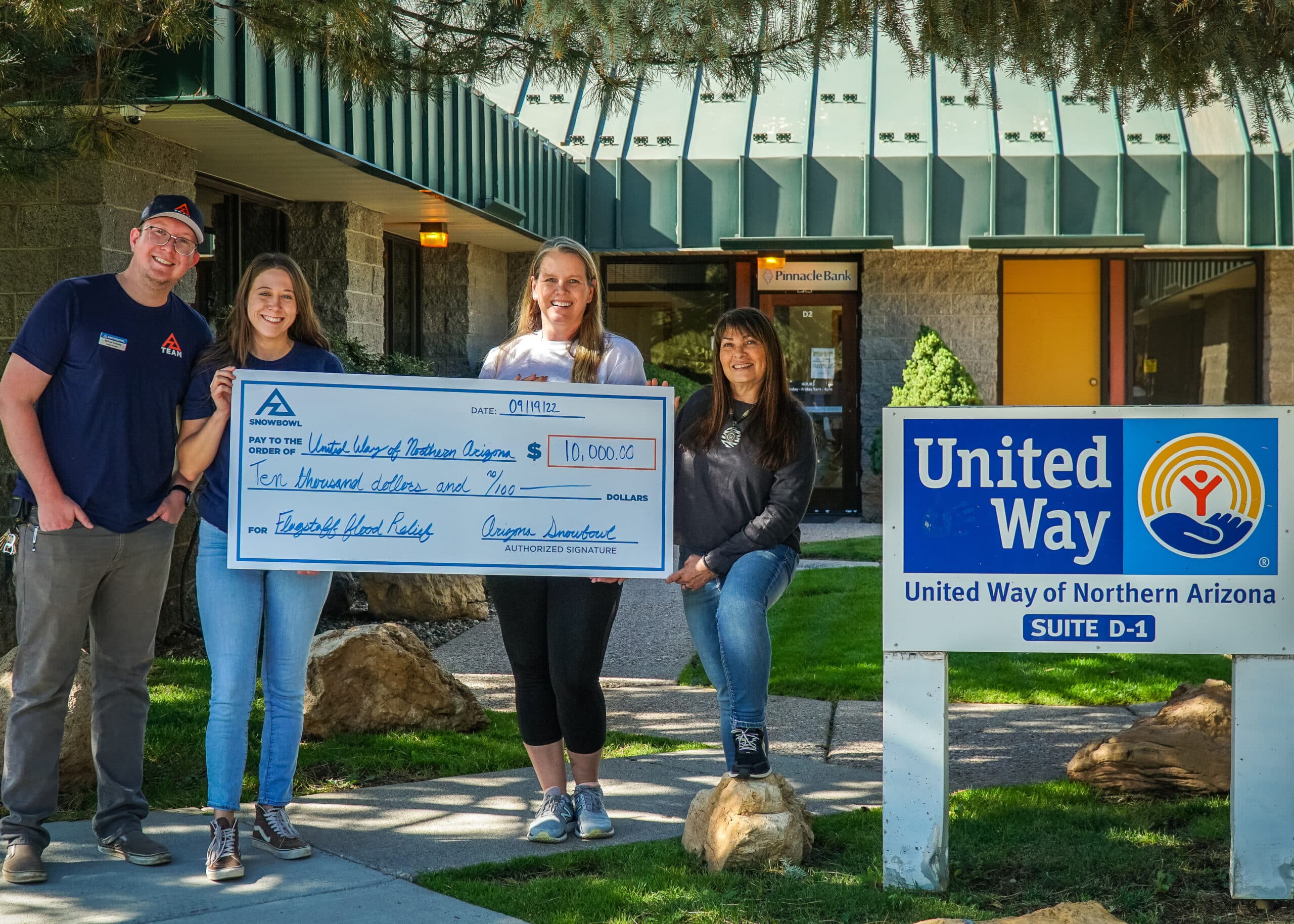 Snowbowl employees handing over $10,000 check to United Way of Northern Arizona.