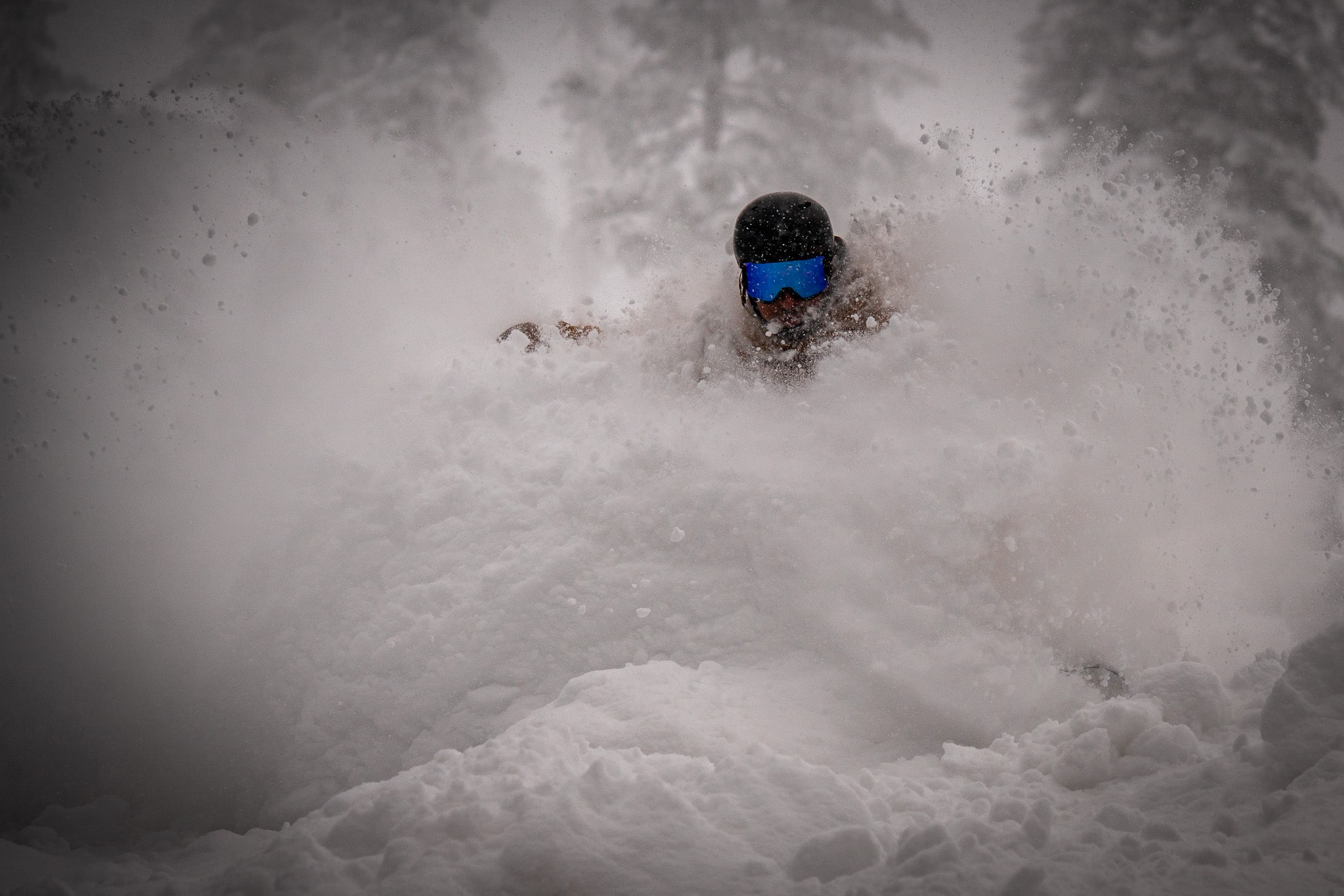 Snowboarder slashing deep powder