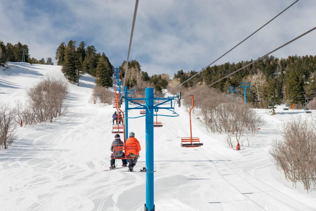 Riders on chairlift at Sandia Peak Ski Area