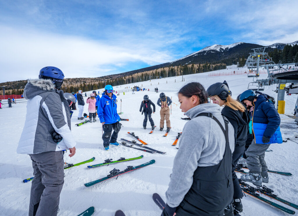 Group of beginner skiers with ski instructor at Snowbowl