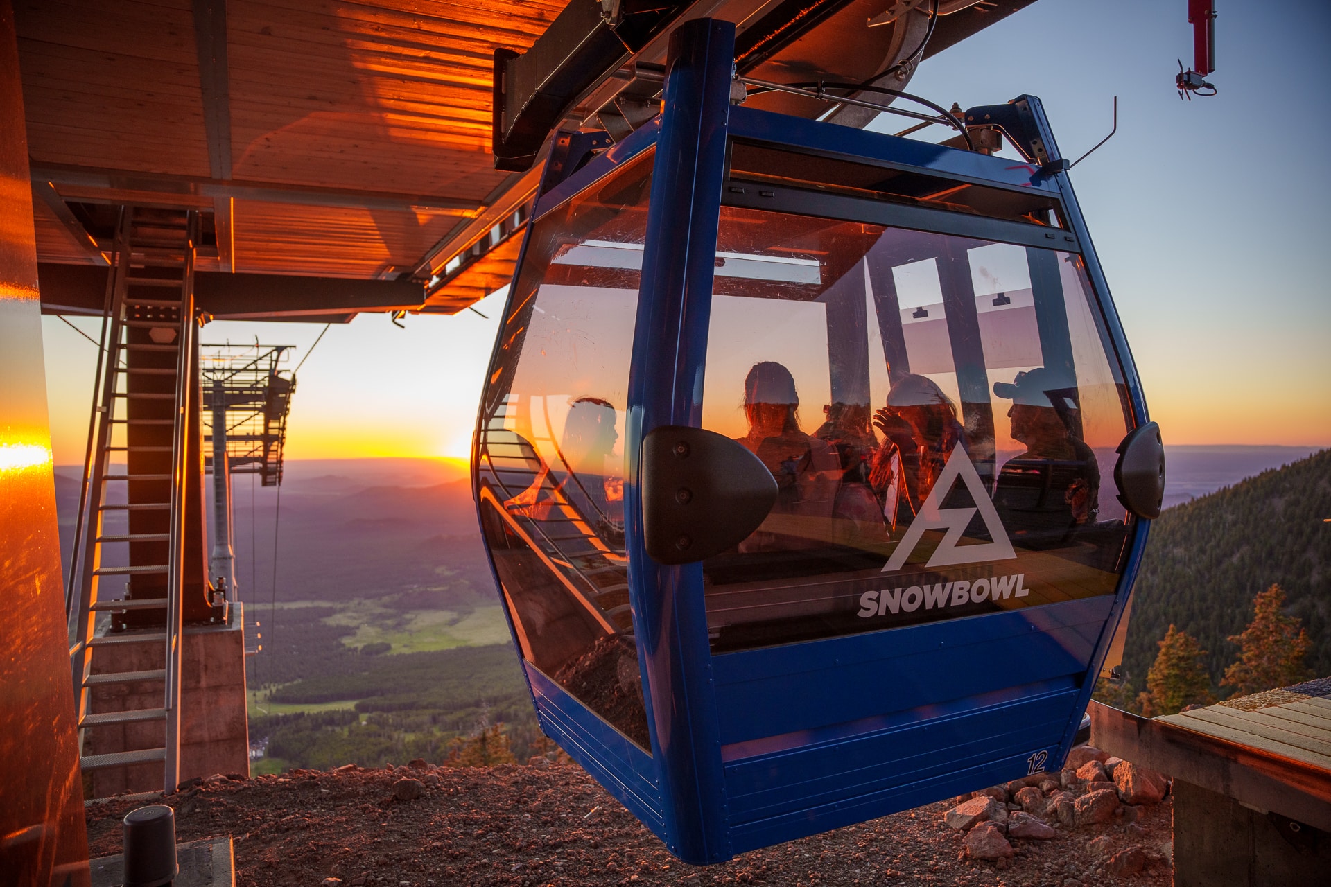 Family riding off into sunset in gondola cabin