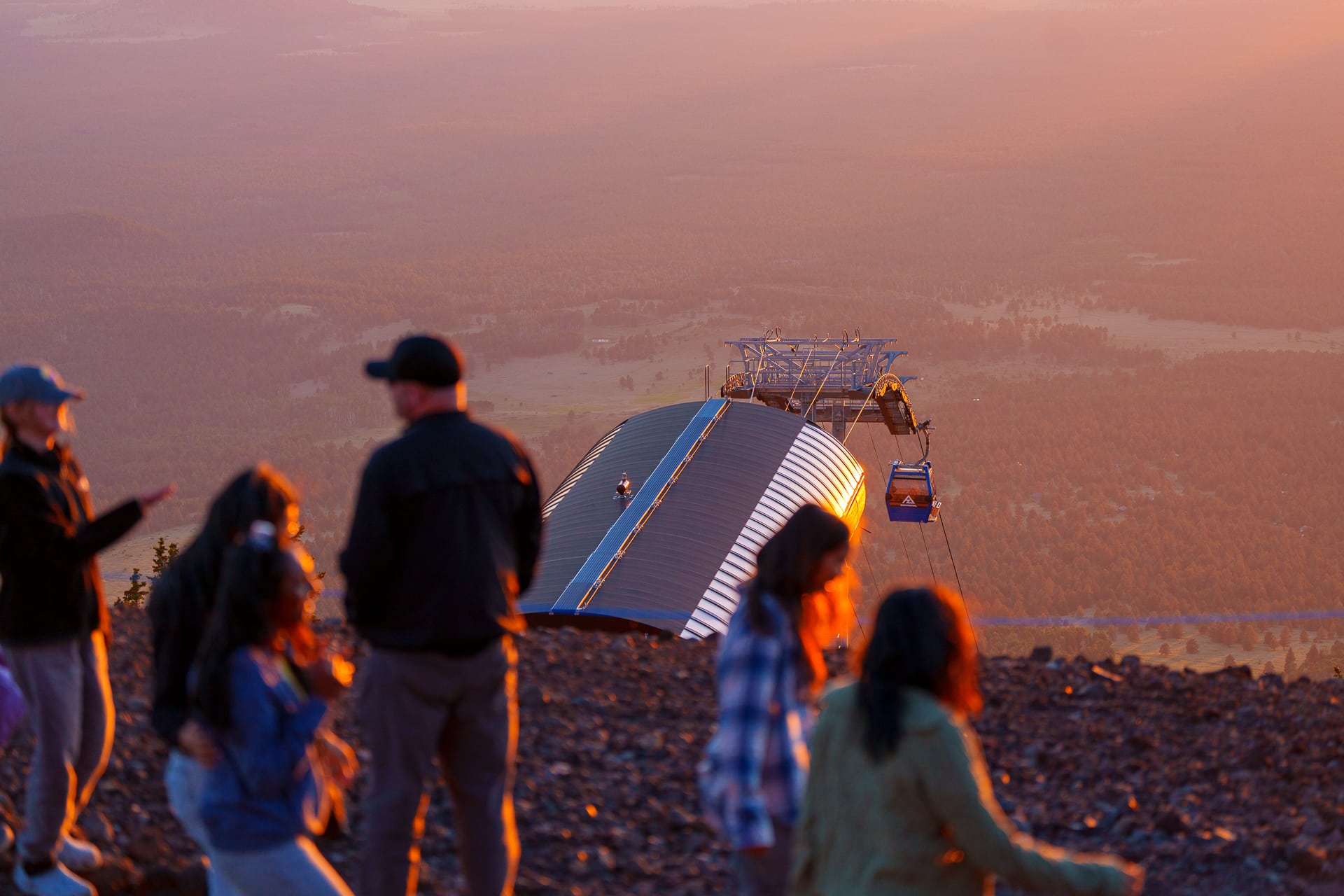 Family in foreground with landscape and gondola in background
