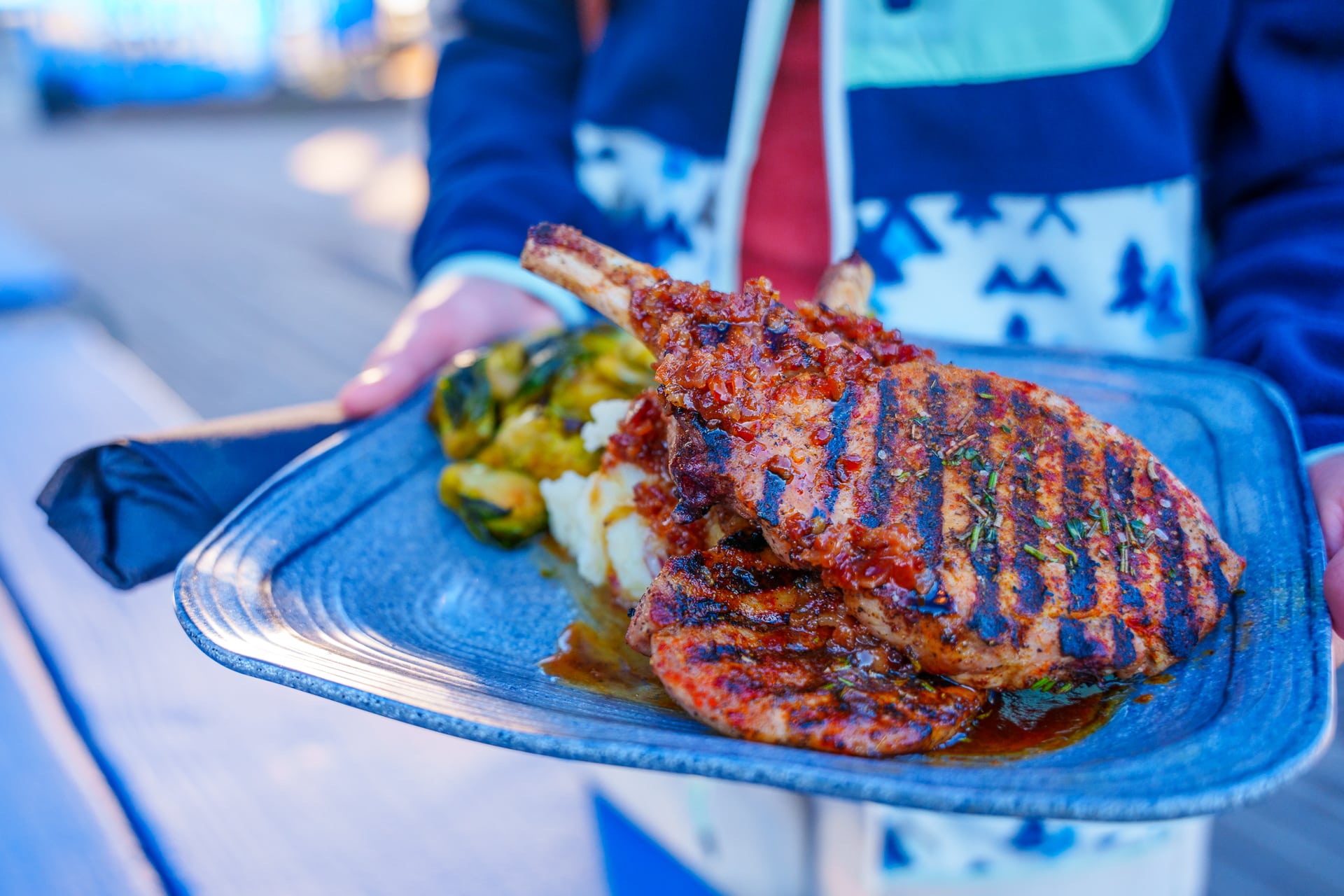 Savory pork chops held out on plate