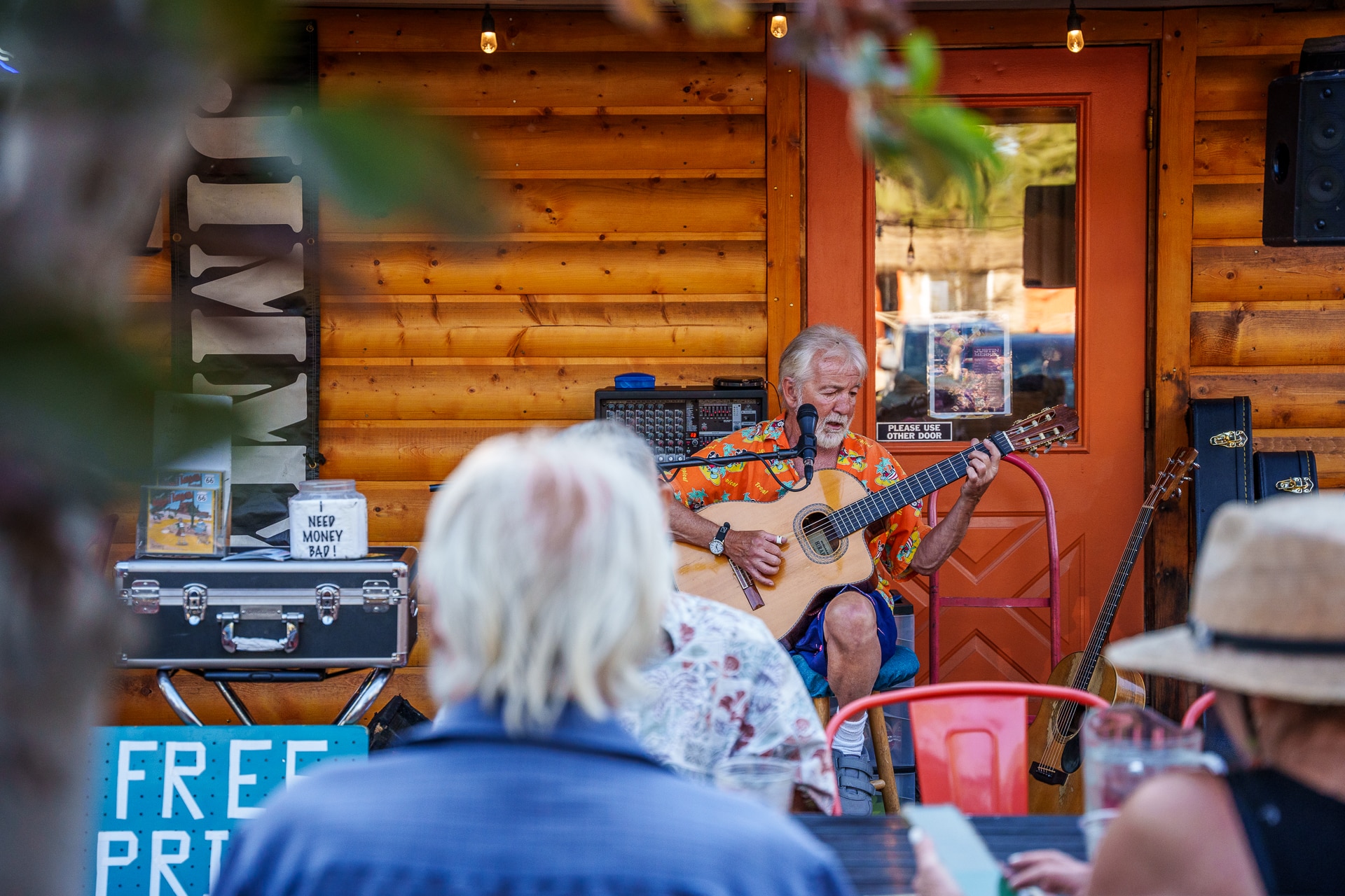 musician playing guitar outside at basecamp