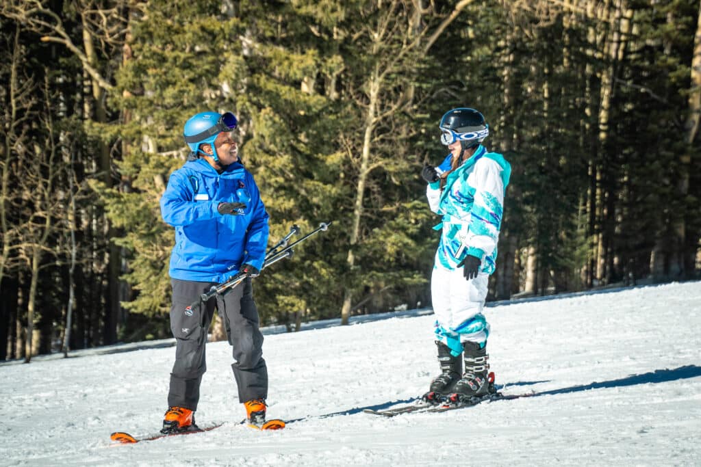 Ski instructor teaches a young skier