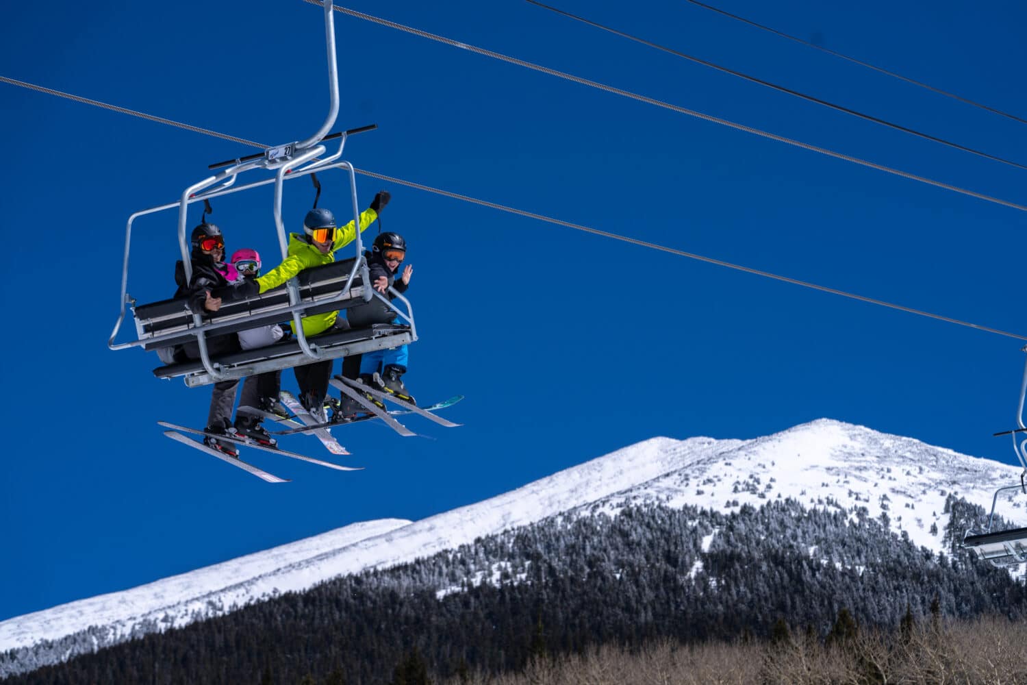 Family of skiers on a chairlift at Snowbowl