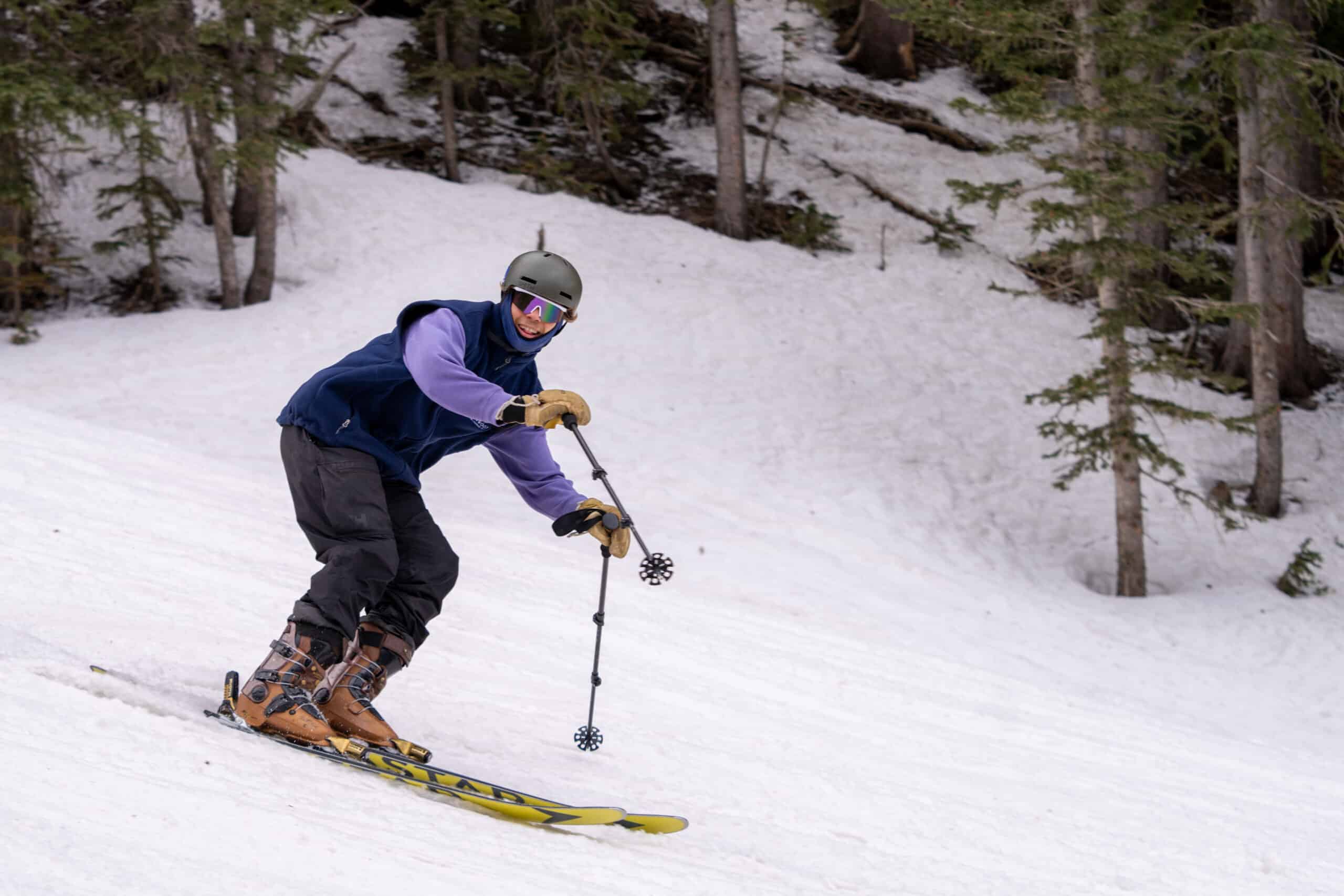 Skier looking towards the camera and smiling on a spring day at Snowbowl