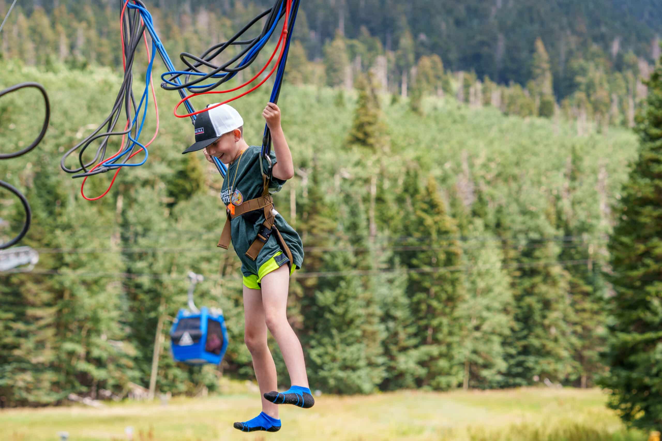 A child using the bungee trampoline at Snowbowl during the summer