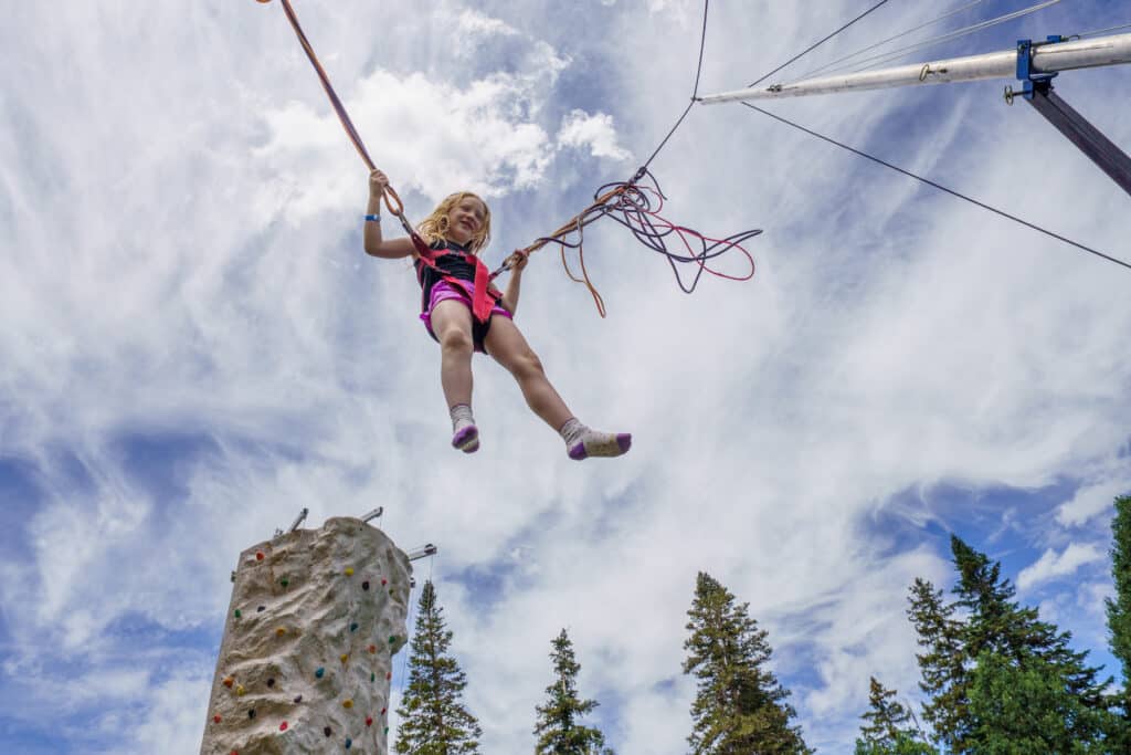 Girl jumping on bungee trampoline