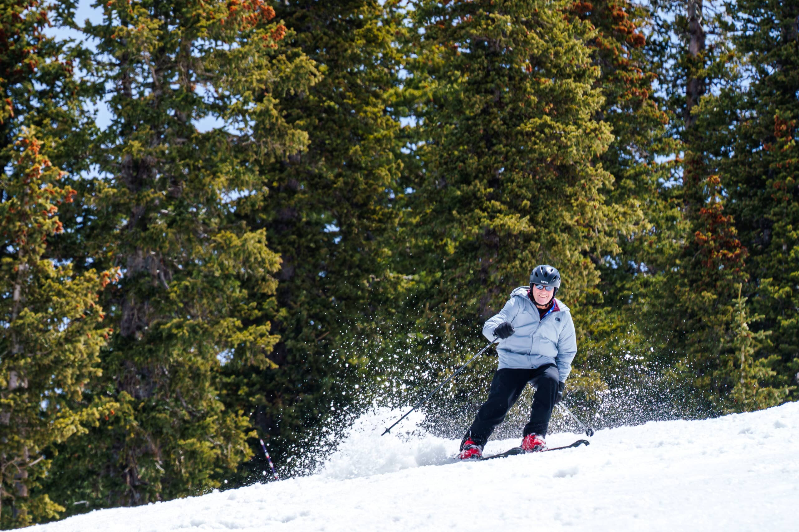 Skier at Snowbowl smiling coming down a run