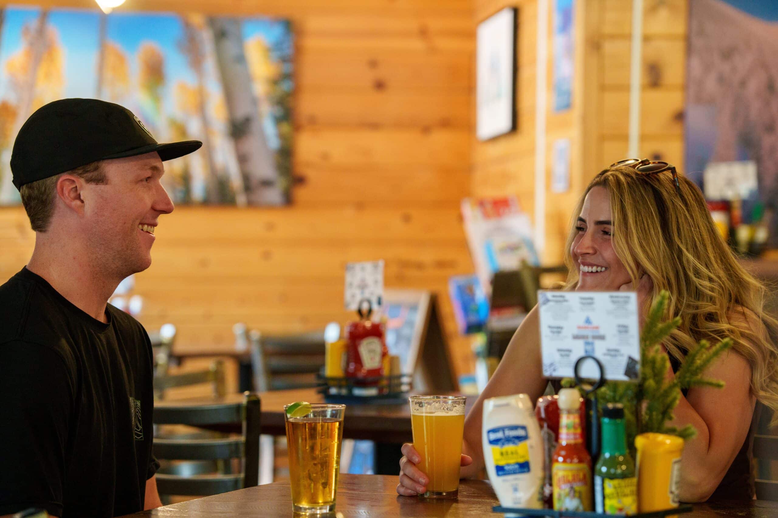 A Couple Smiling With Drinks at Basecamp