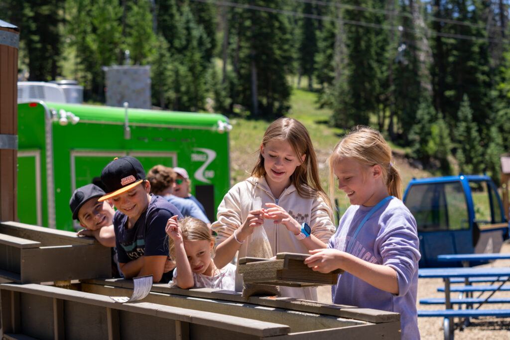 Group of kids panning for treasure during summer activities