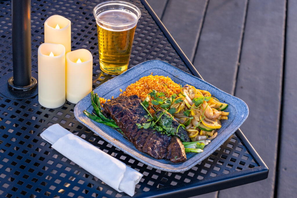 Elevated Asada served up next to a beer.