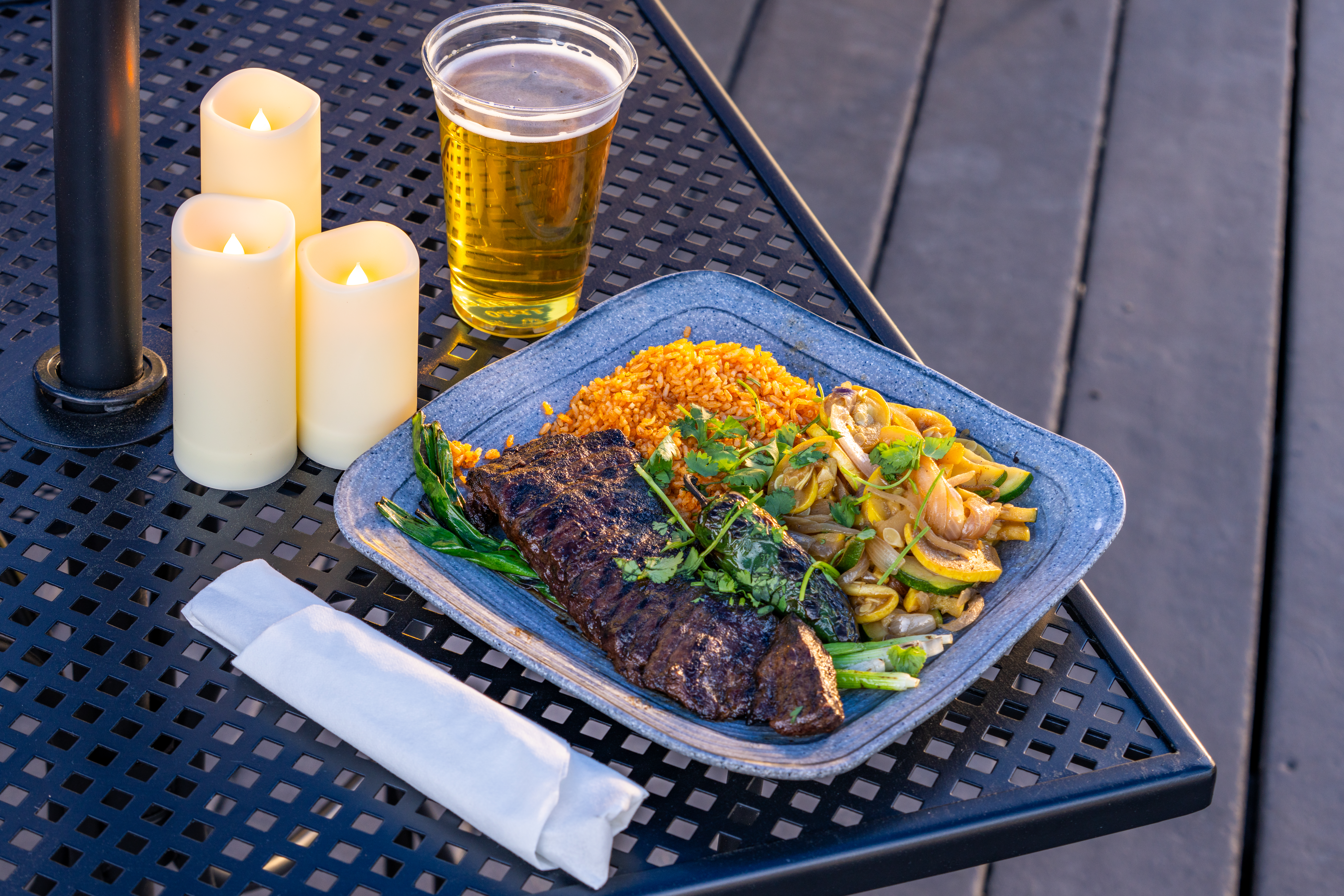Elevated Asada served up next to a beer.