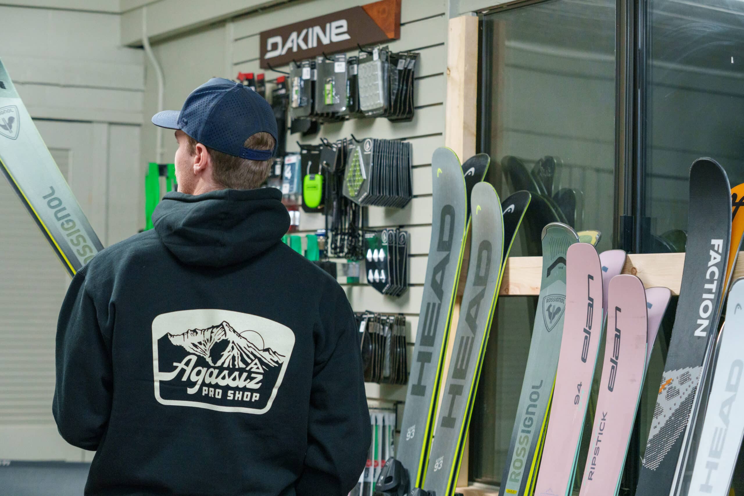 Agassiz Pro Shop employee setting up a pair of demo skis