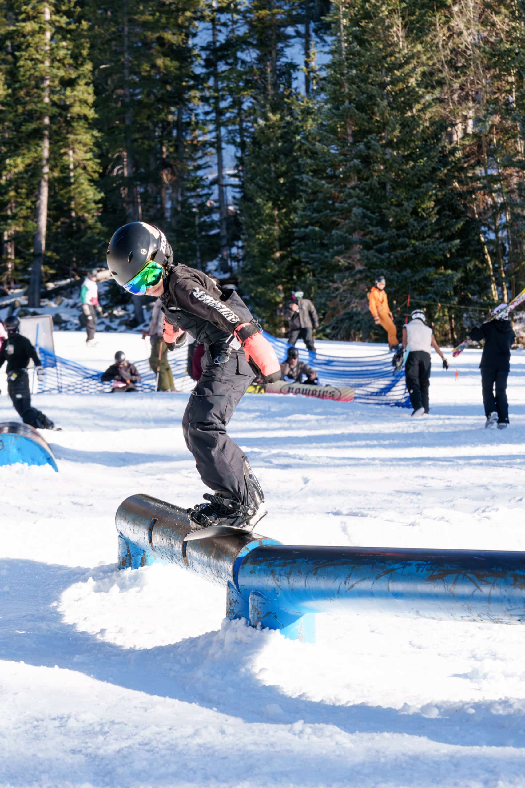 A young snowboarder on a rail in Round Up Rail Garden