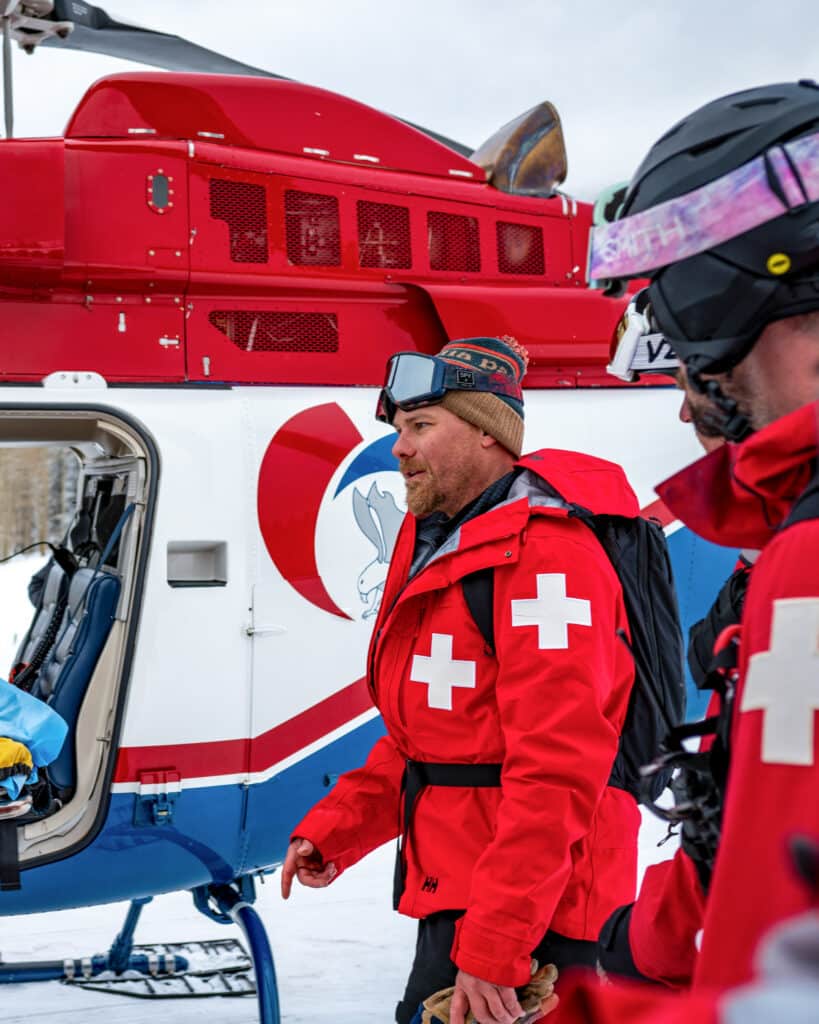 Ski Patroller next to an air evac helicopter