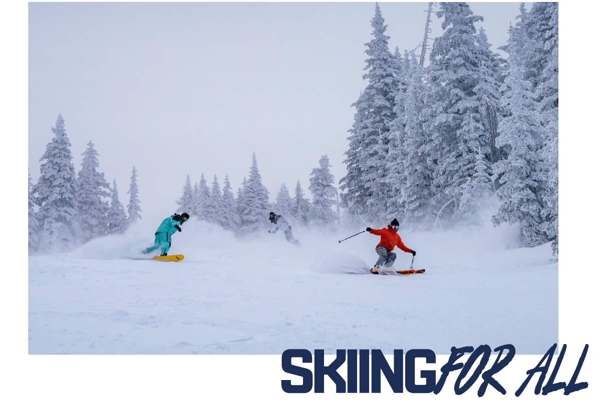 Skiing For All - a skier and two snowboarders coming down Lower Volcano during a powder day at Snowbowl