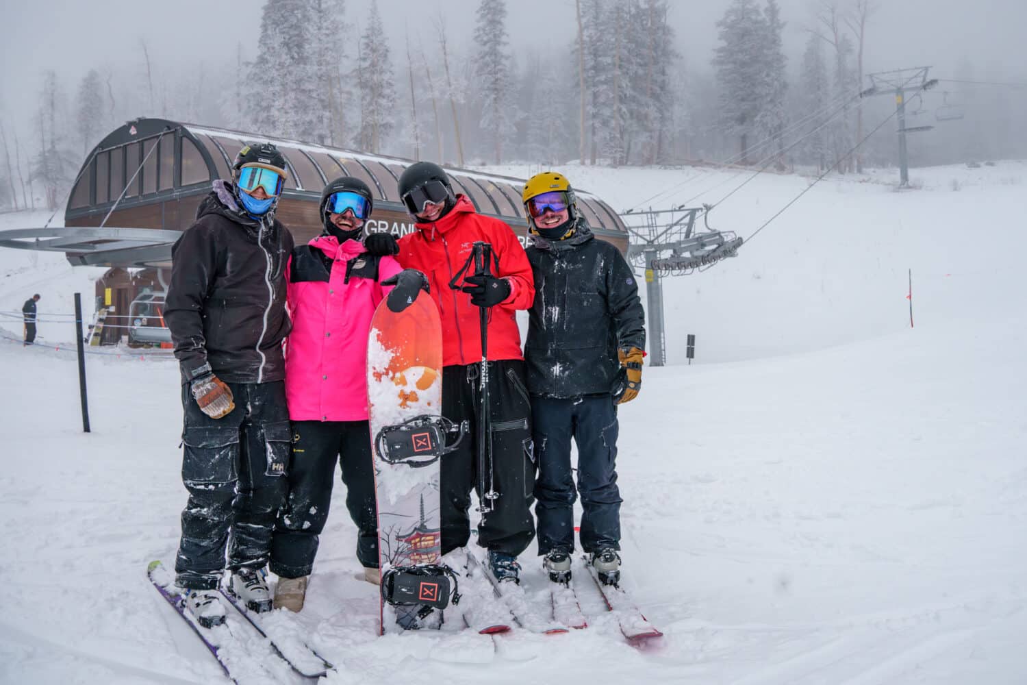 A group of friends, skiers and snowboarders, at the bottom of the Grand Canyon Express chairlift