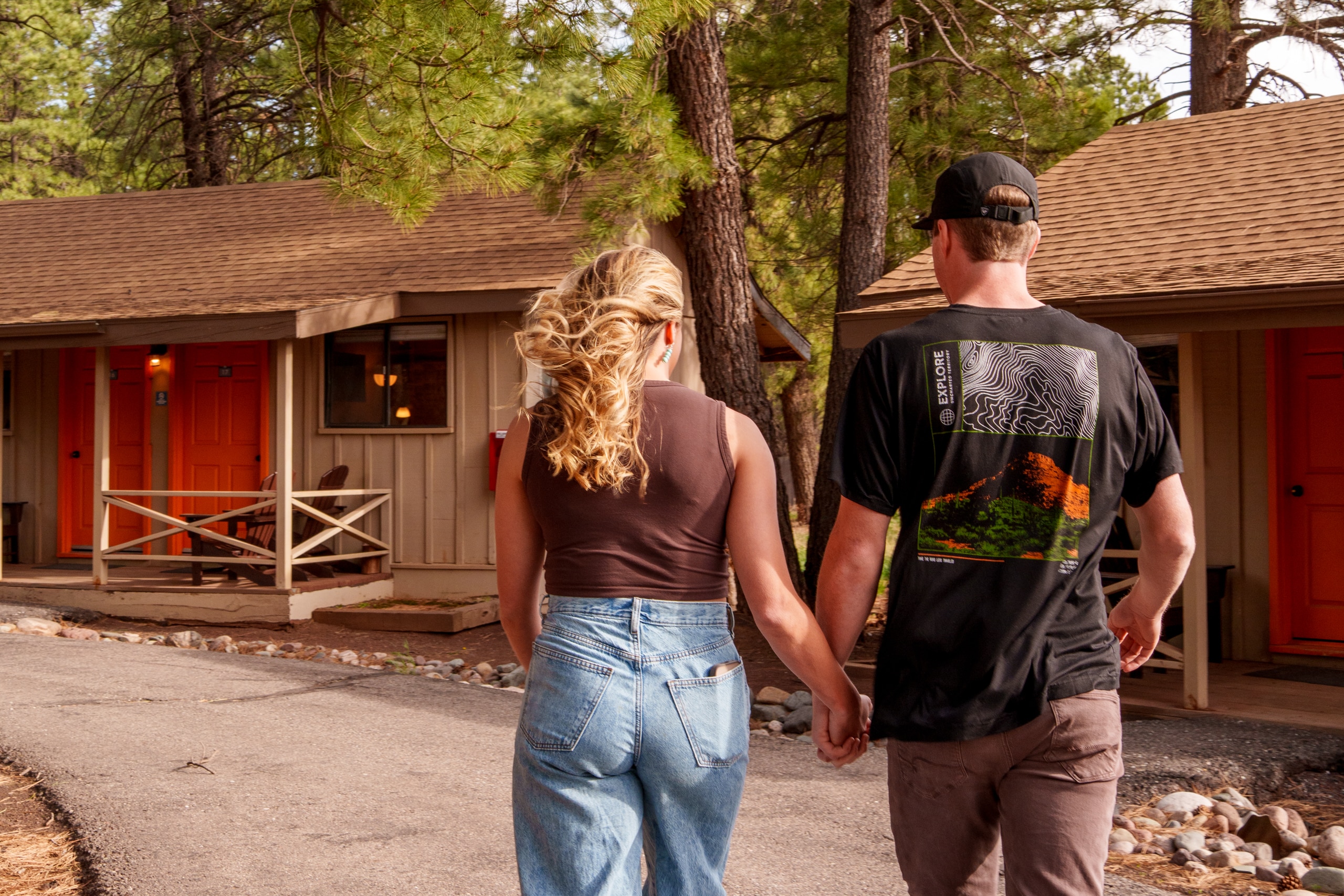 A couple at Basecamp, holding hands, heading to their cabin room