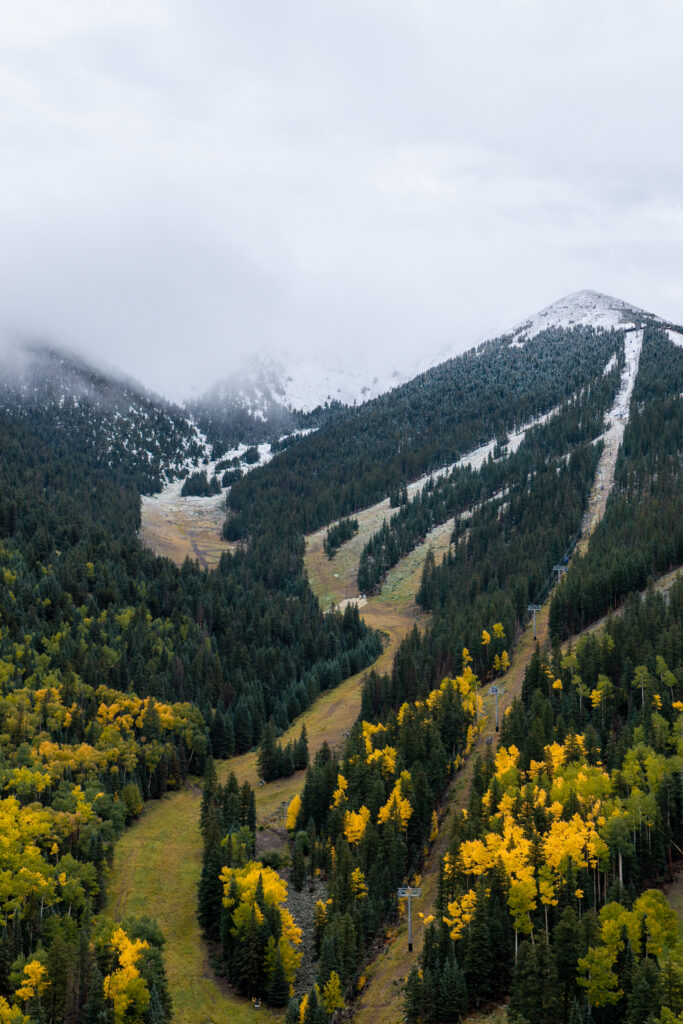 Fall colors and first snowfall collide on the mountain